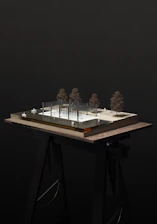 a model of a building with trees on top of it