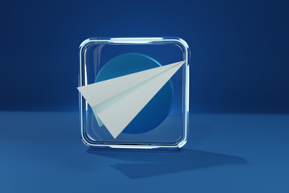 a paper airplane is in a glass box