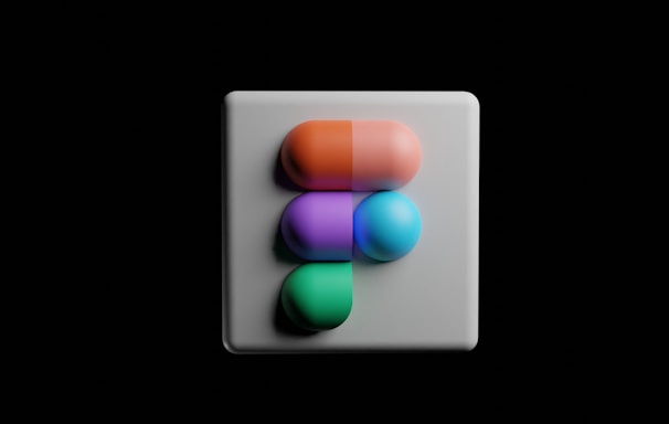 a white square button with a multicolored object on it