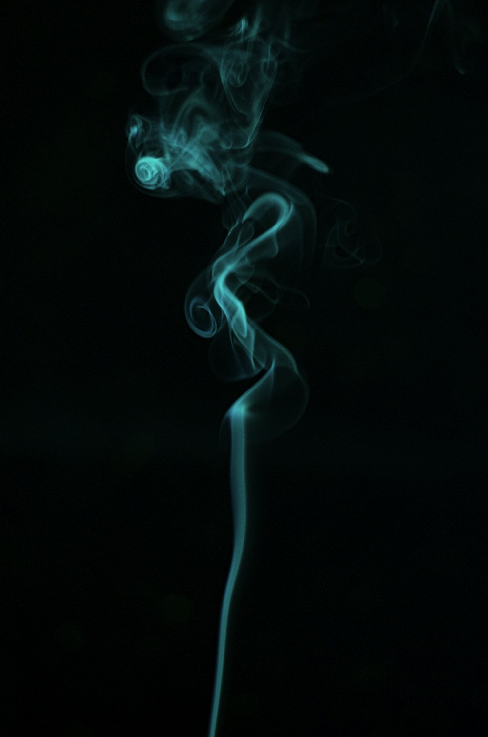 smoke is shown in the dark with a black background