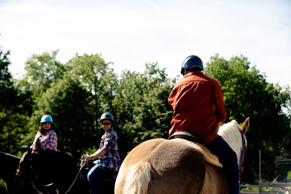 a couple of people riding on the back of horses