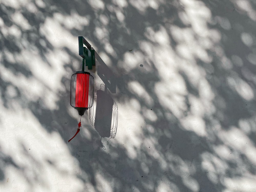 a red light hanging from the side of a building