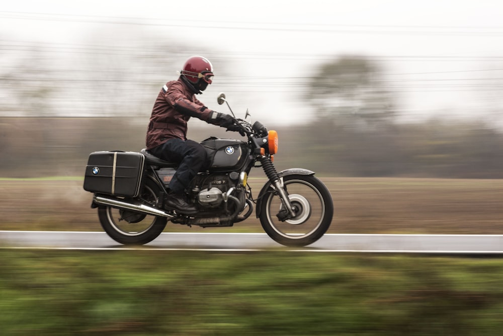 a man riding a motorcycle down a road