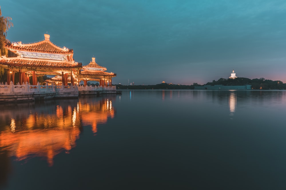 a large body of water with a building in the background