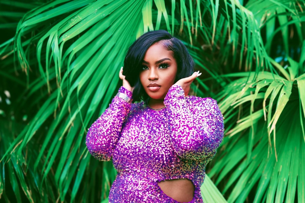 a woman in a purple dress posing for a picture