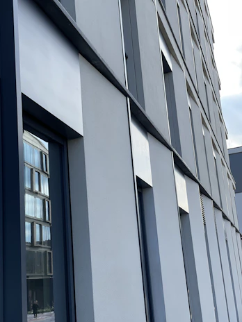 Exterior facade showing clean, precise exterior plaster work on a modern building.