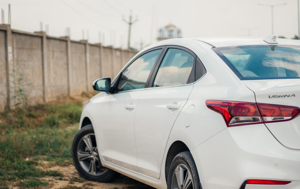 a white car parked on the side of a road