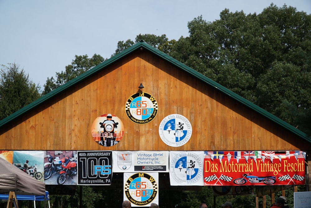 a wooden building with a number of signs on it