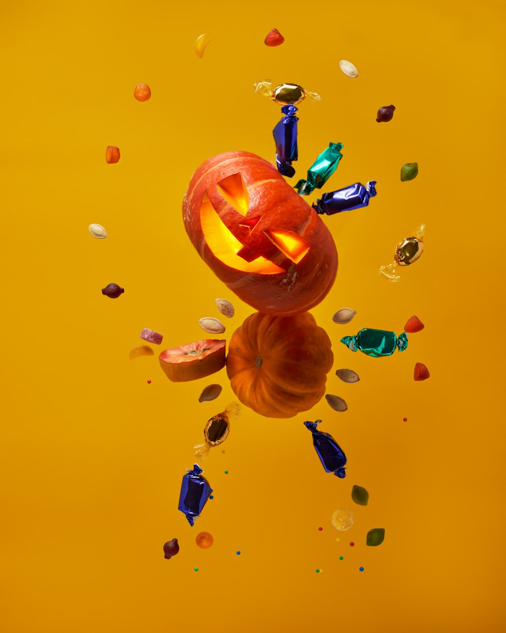 a jack - o'- lantern is surrounded by confetti and confe