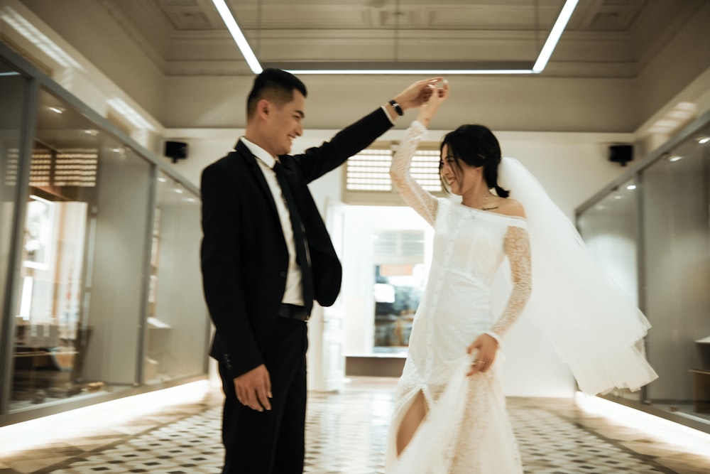 a man and a woman dressed in wedding attire