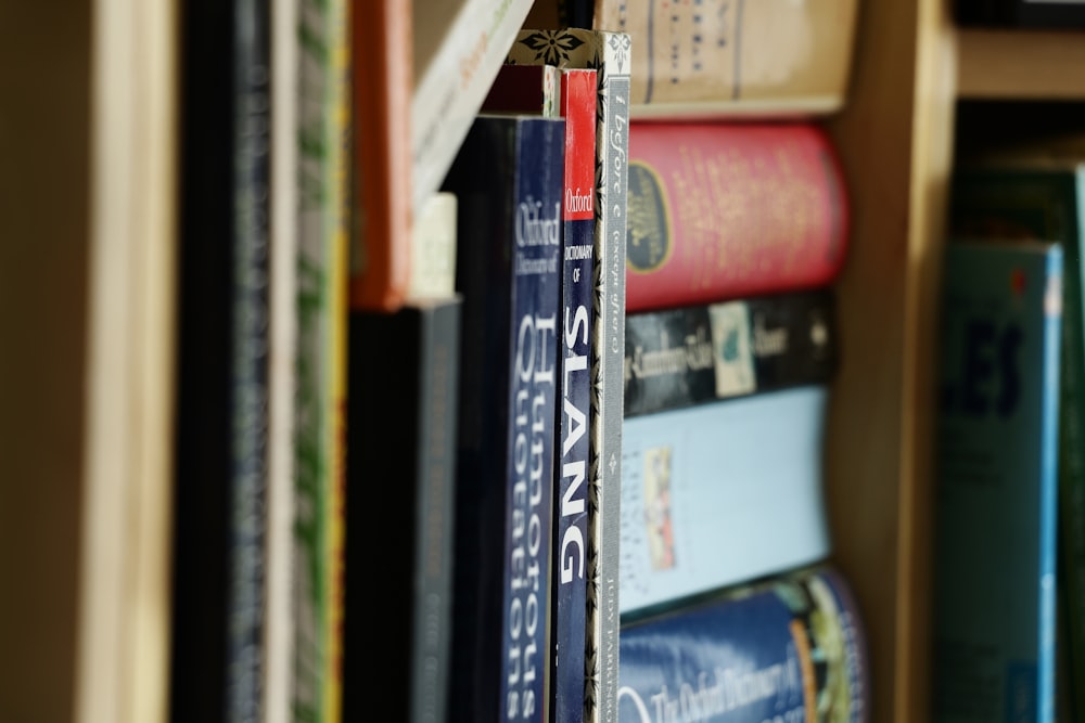 a close up of a book shelf filled with books