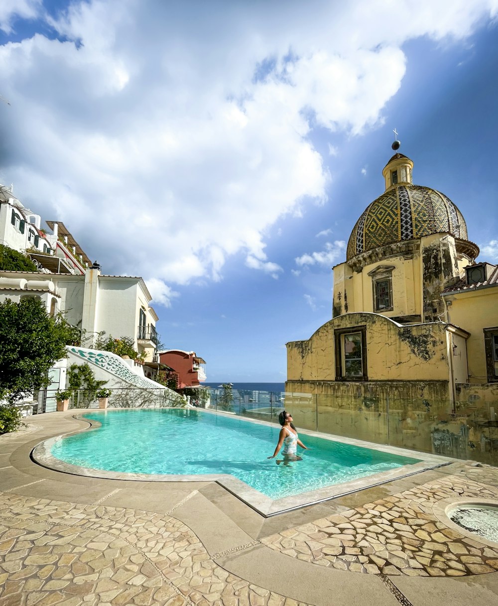 a woman is sitting in a swimming pool