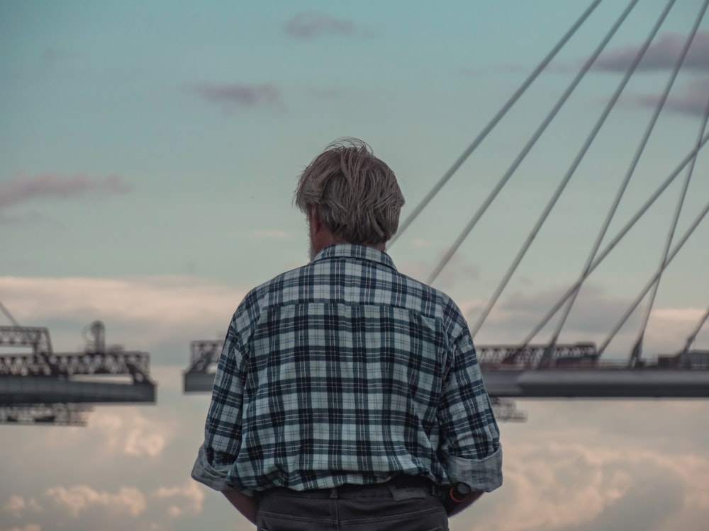 a man standing in front of a body of water