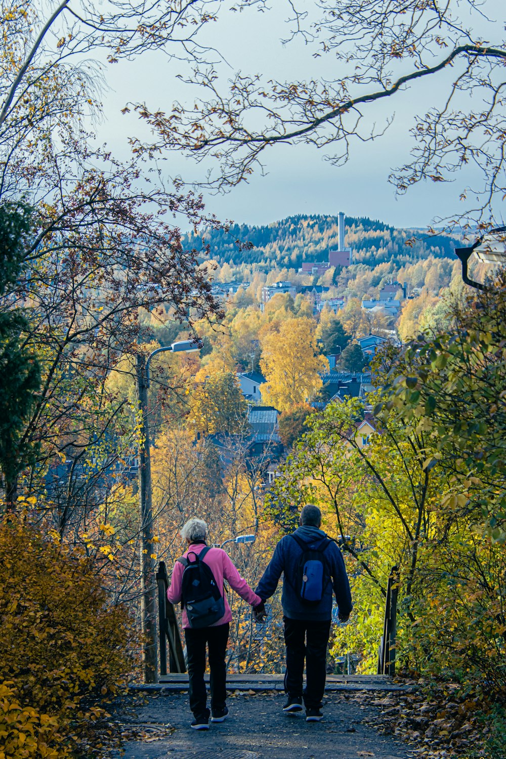 two people walking down a path holding hands