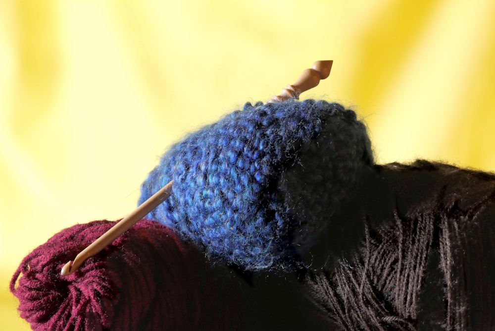 a close up of a yarn ball and a knitting needle
