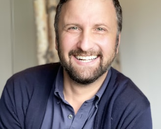 a man with a beard and a blue shirt