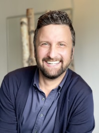 a man with a beard and a blue shirt