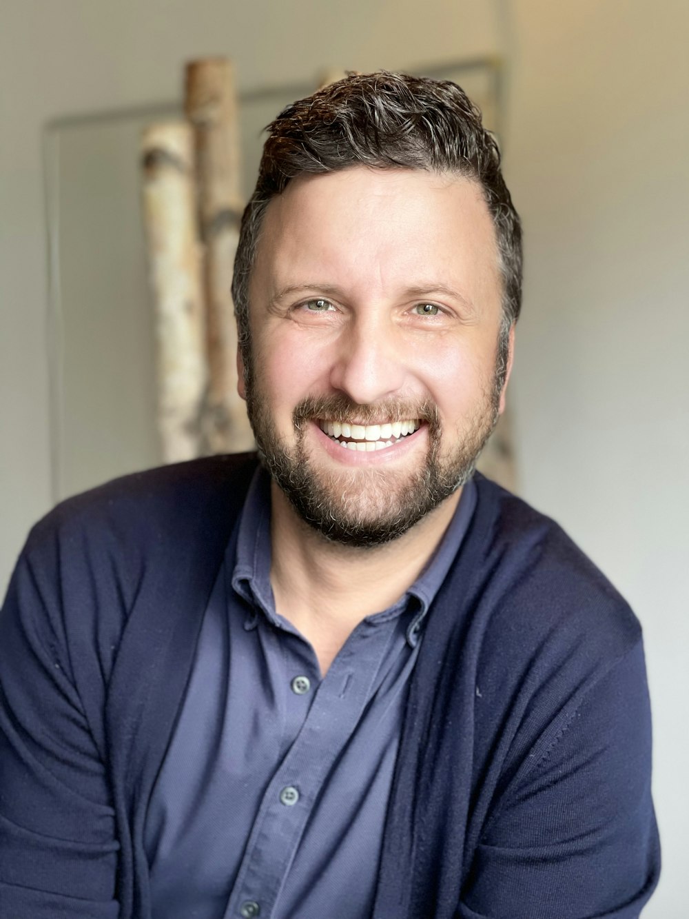 a man with a beard and a blue shirt