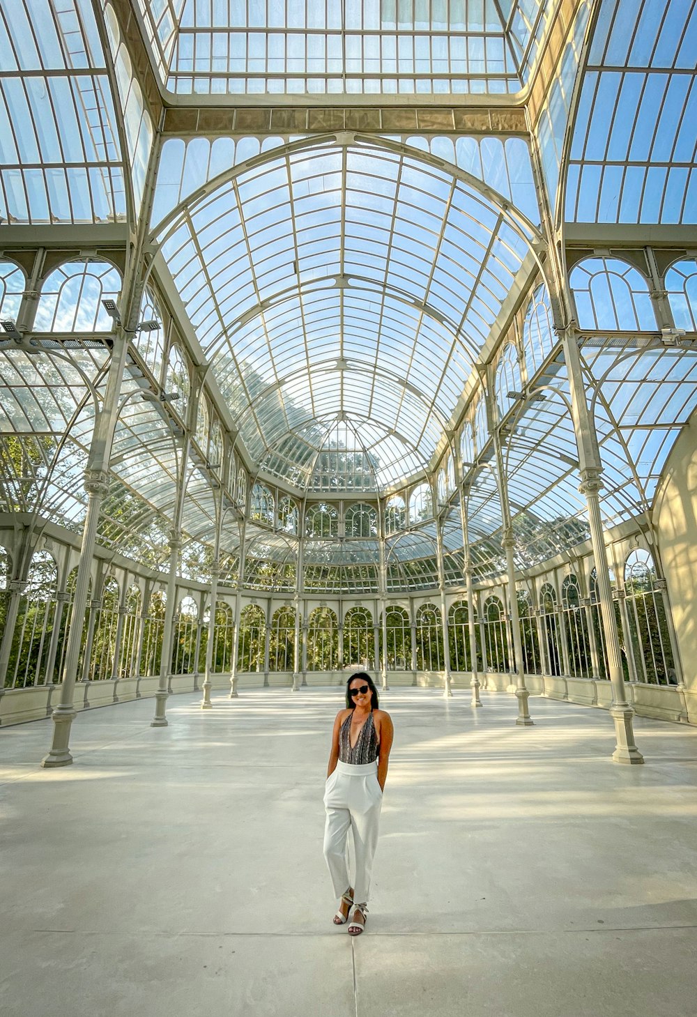 a woman is standing in a large building