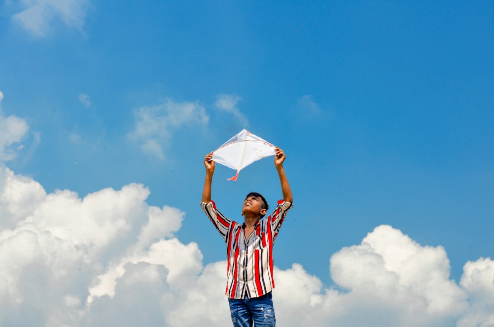 a man holding a kite in the air