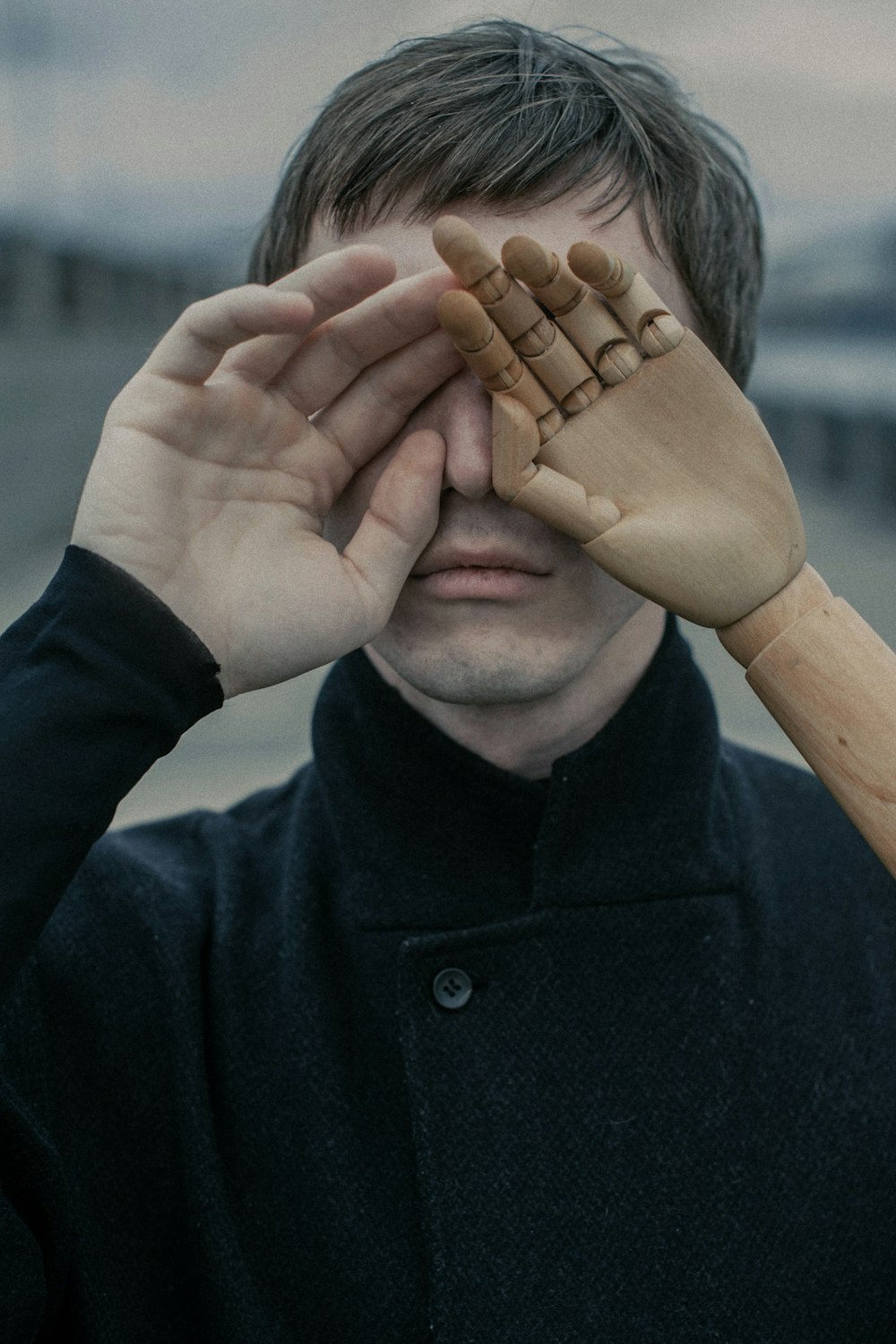 a man holding a baseball bat over his eyes