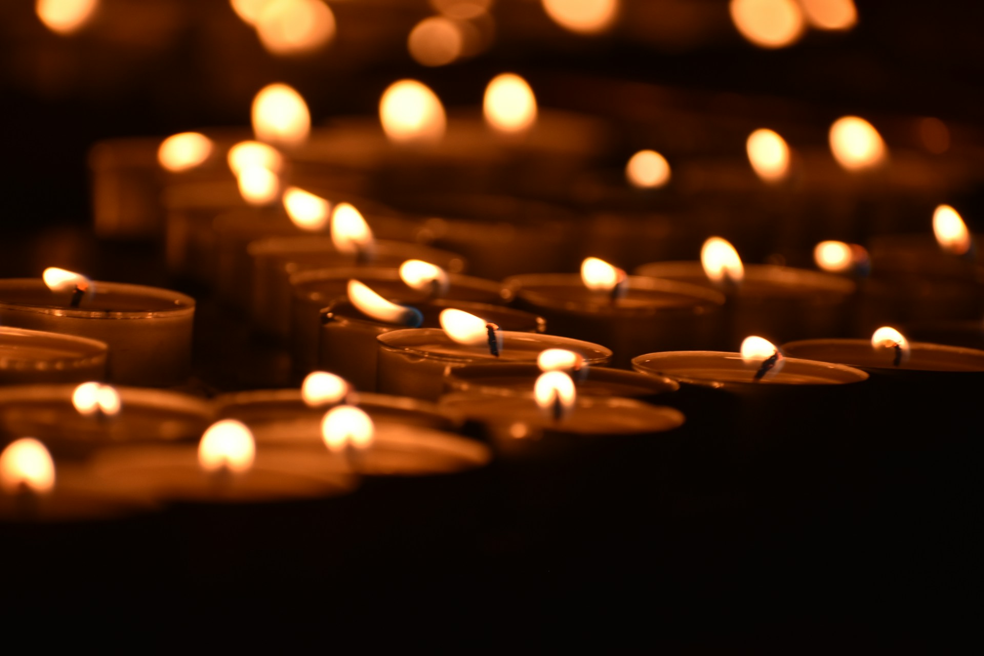a group of lit candles sitting next to each other