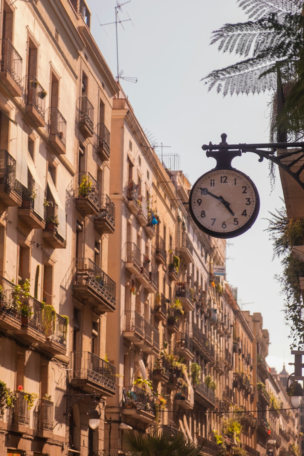 a clock hanging from the side of a building