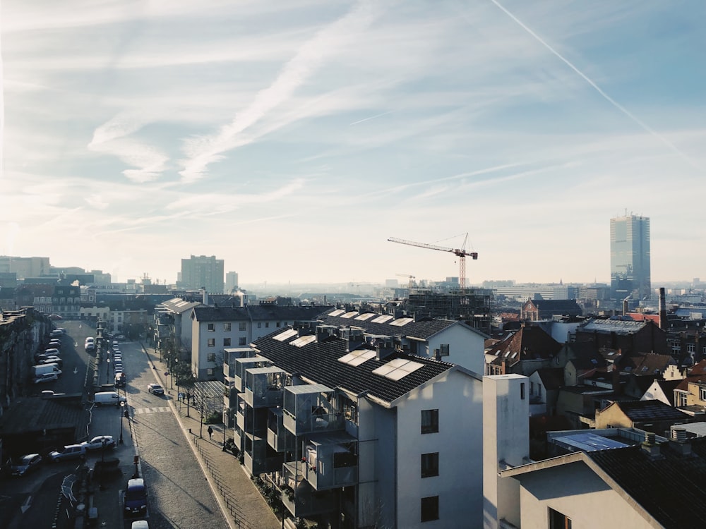 a view of a city with a crane in the sky