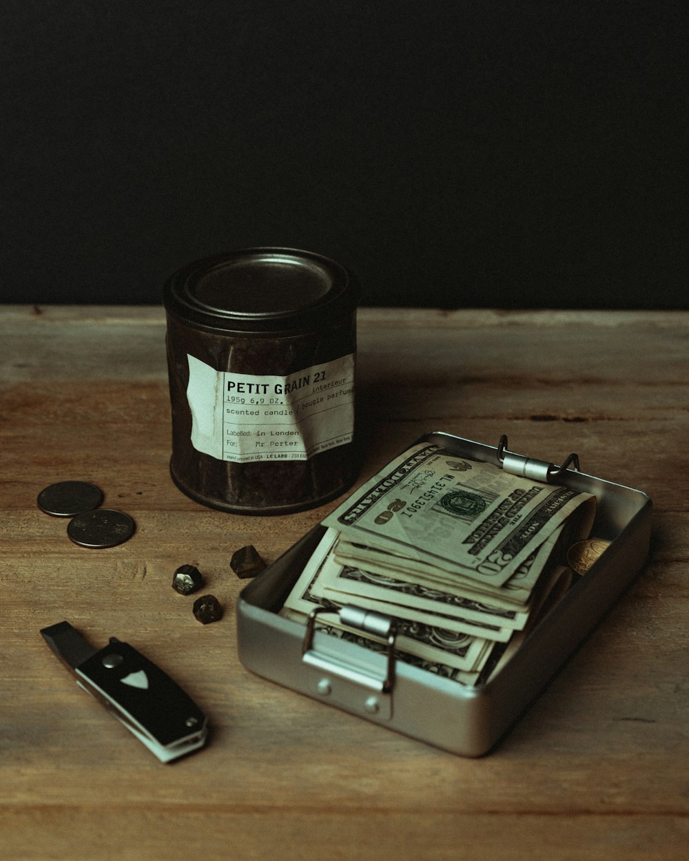 a bunch of money sitting on top of a wooden table