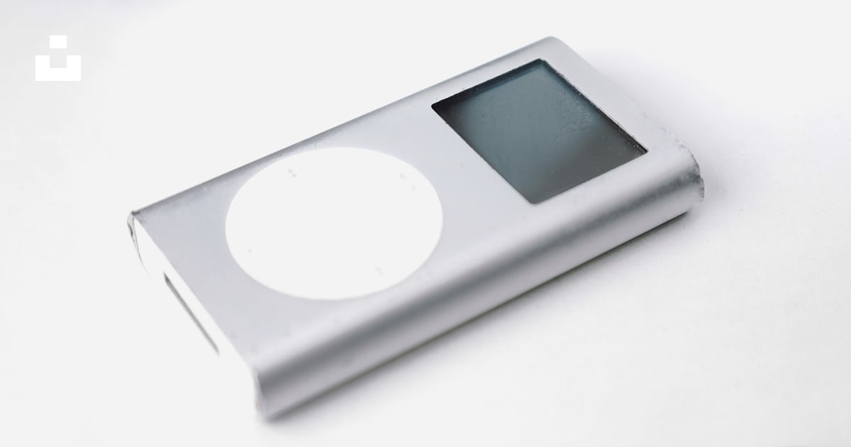 An ipod sitting on top of a table next to headphones photo – Free White ...