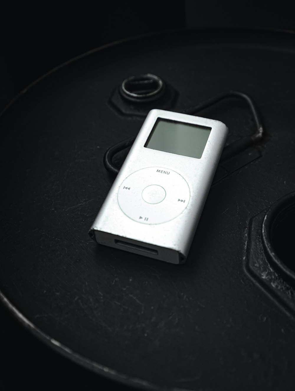 an ipod sitting on top of a black table