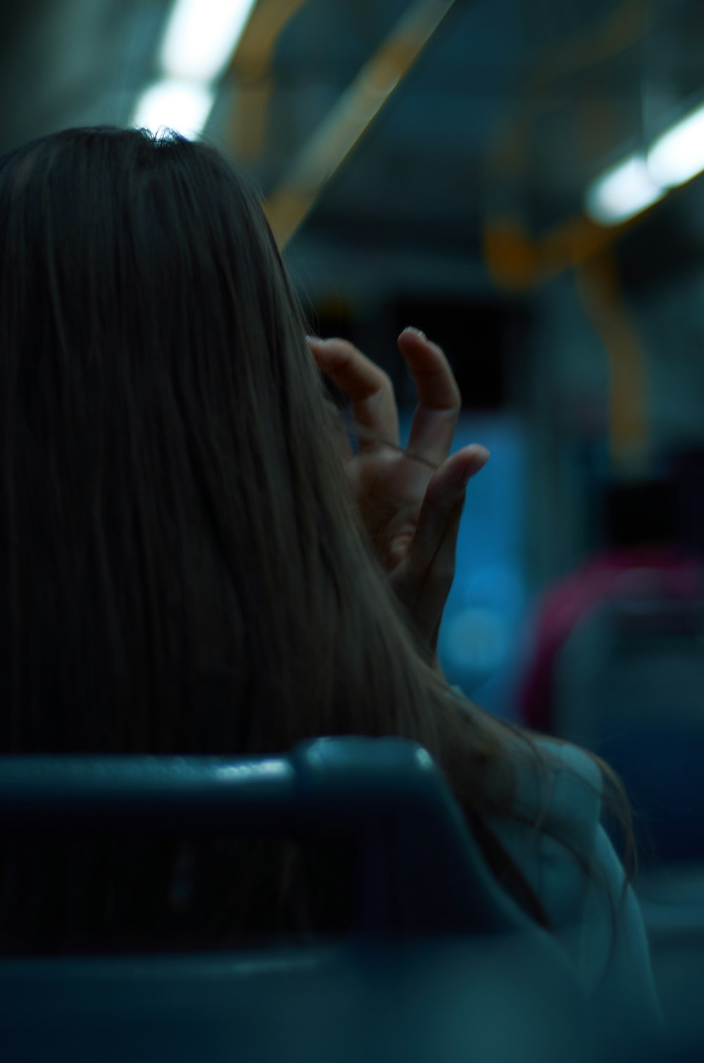 a woman with long hair sitting on a bus