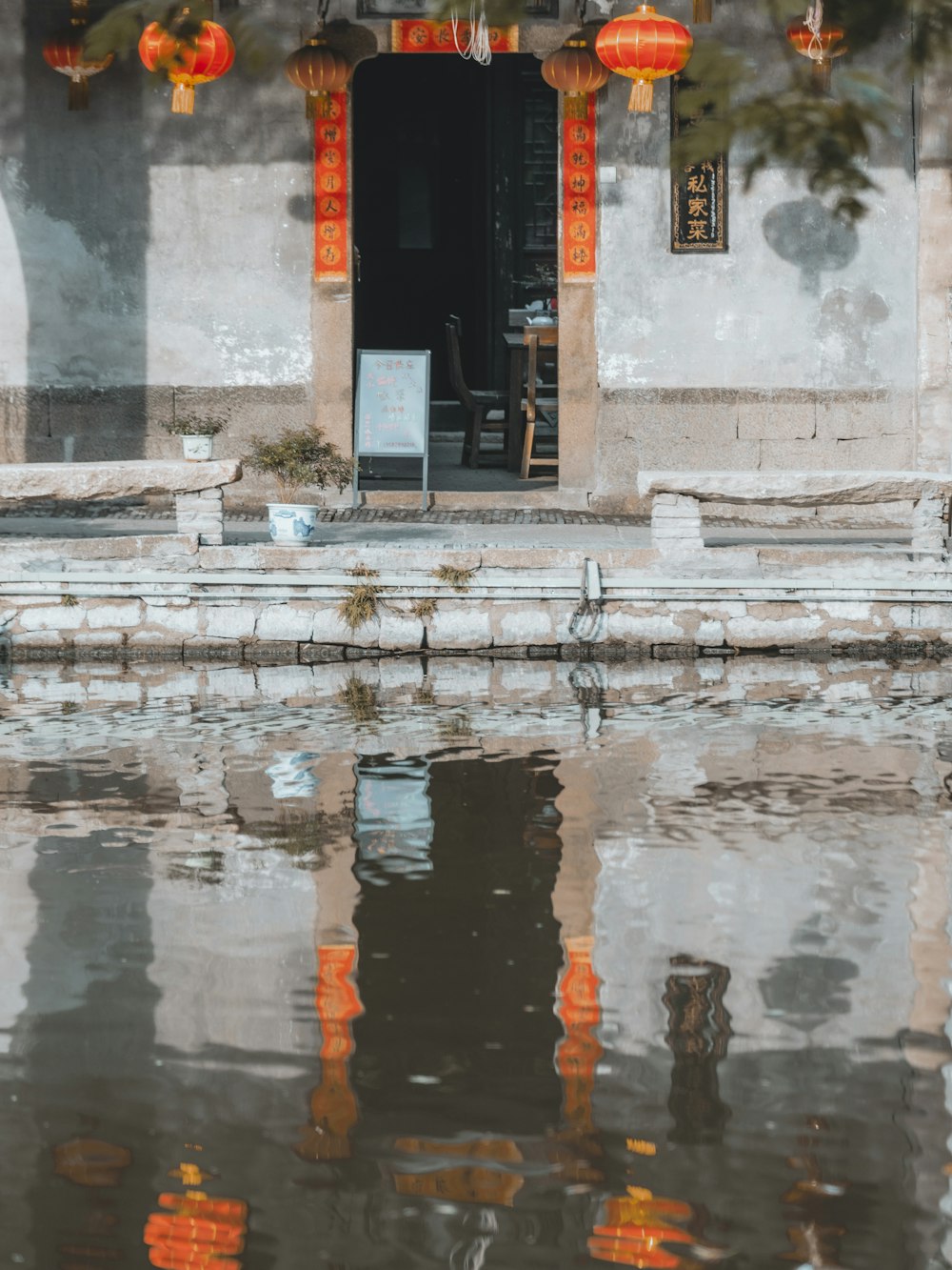 a person sitting on a bench near a body of water