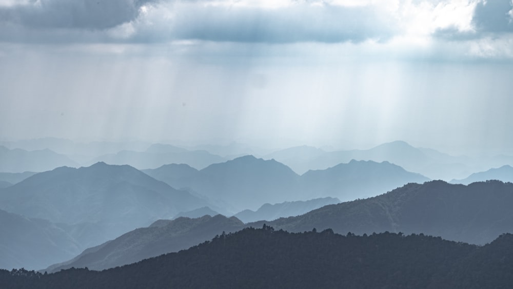 a view of a mountain range under a cloudy sky