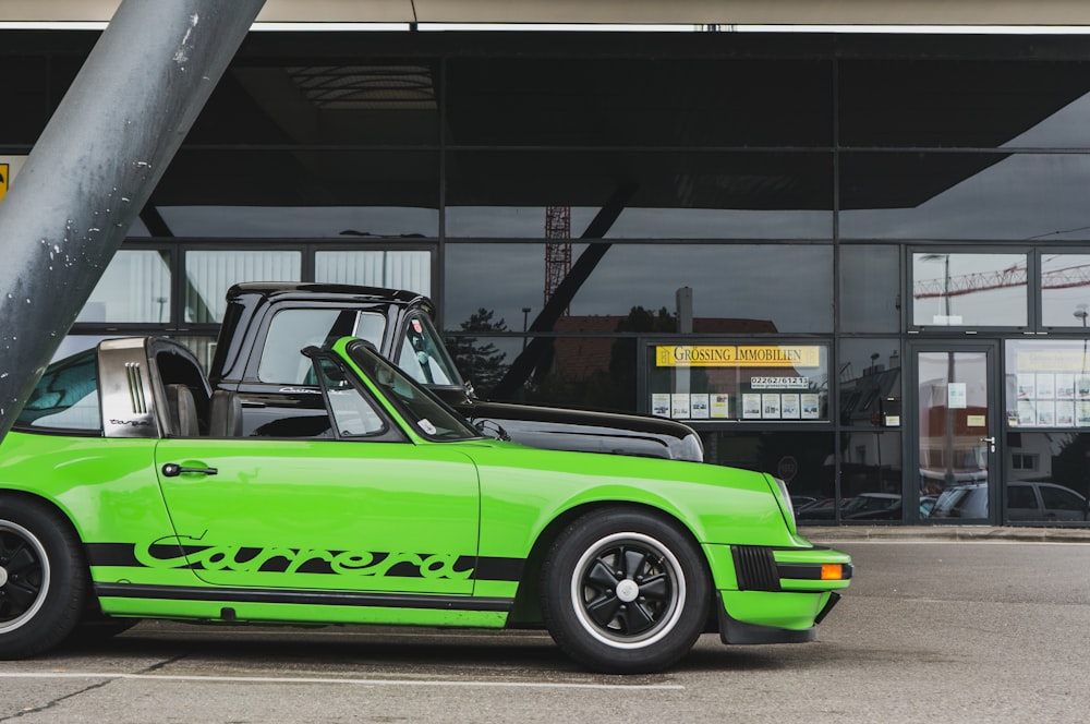 a green car parked in front of a building