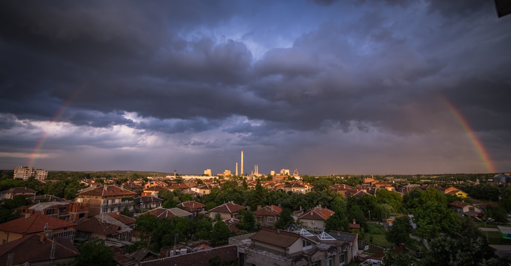 a view of a city with a rainbow in the sky