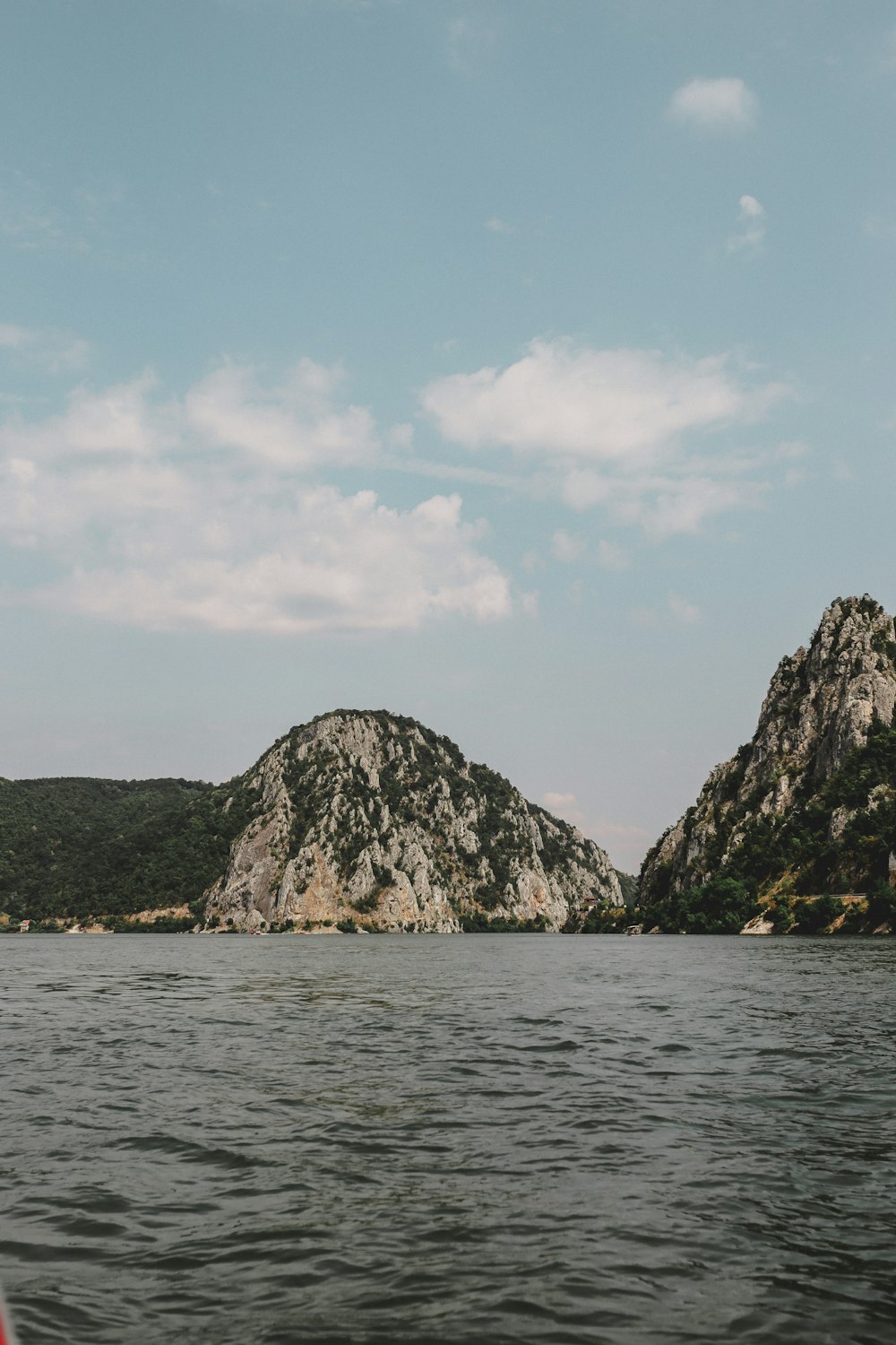 a body of water with a mountain in the background