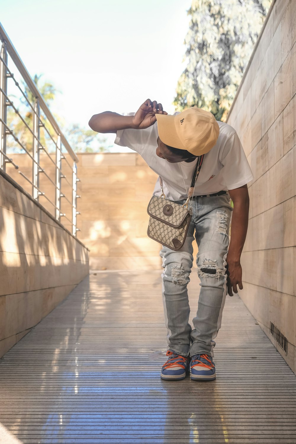 a man in a hat is walking down a ramp