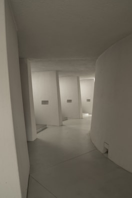 Minimalist museum interior with natural light highlighting clean lines and textured walls.