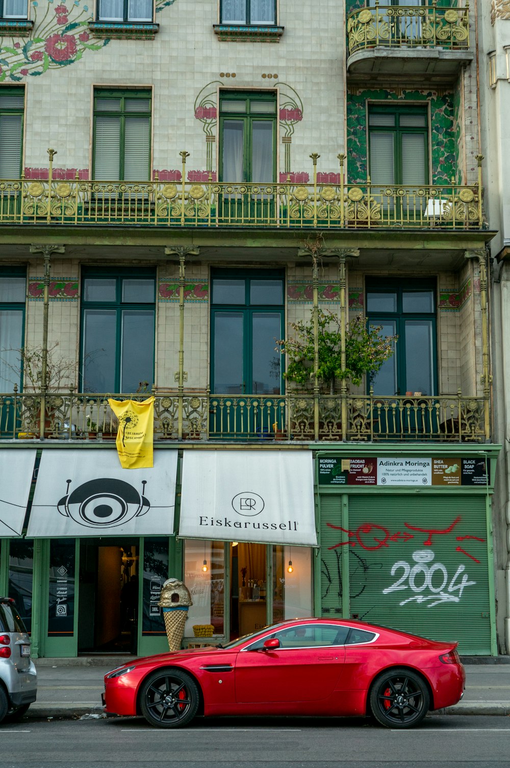 a red sports car parked in front of a building