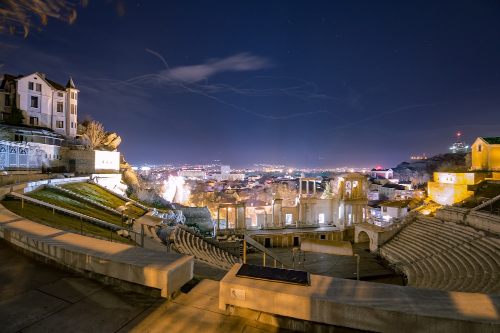 a view of a city at night from the top of a hill