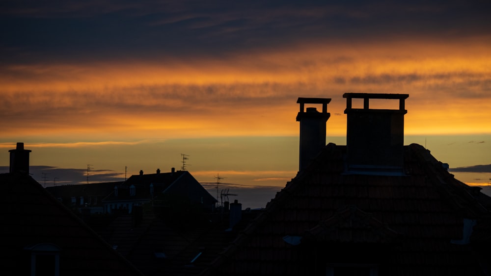 a view of a sunset from a rooftop of some buildings