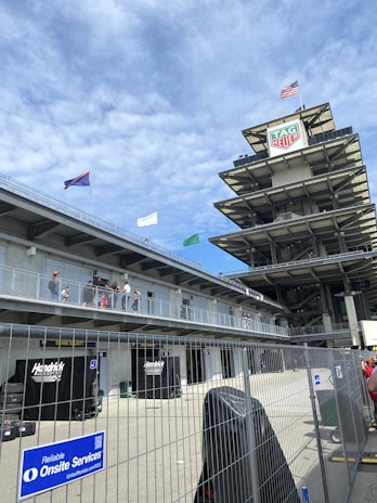 A vibrant shot of the Interlagos Hub storefront with racing flags fluttering in the breeze.