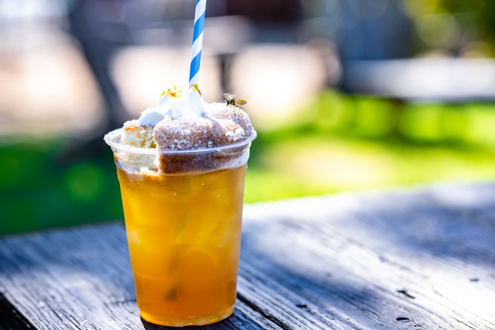 a drink with a straw in it sitting on a table