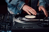 a person touching a record on a turntable
