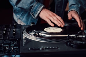 a person touching a record on a turntable