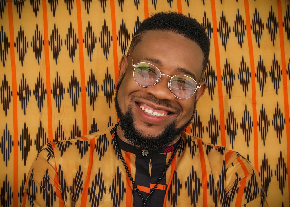 a man with a beard and glasses smiling