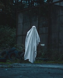 a white ghost standing in front of a building
