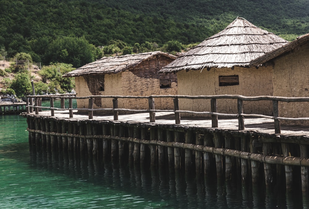 a wooden dock with a hut on top of it