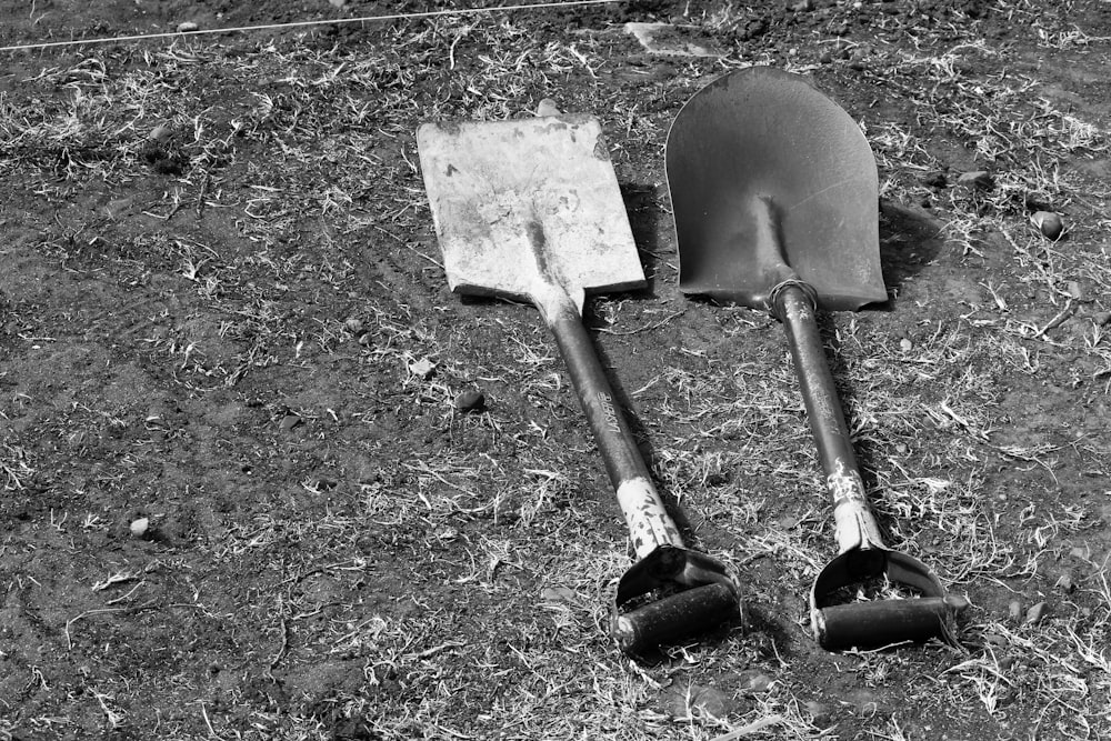 a pair of shovels laying on the ground